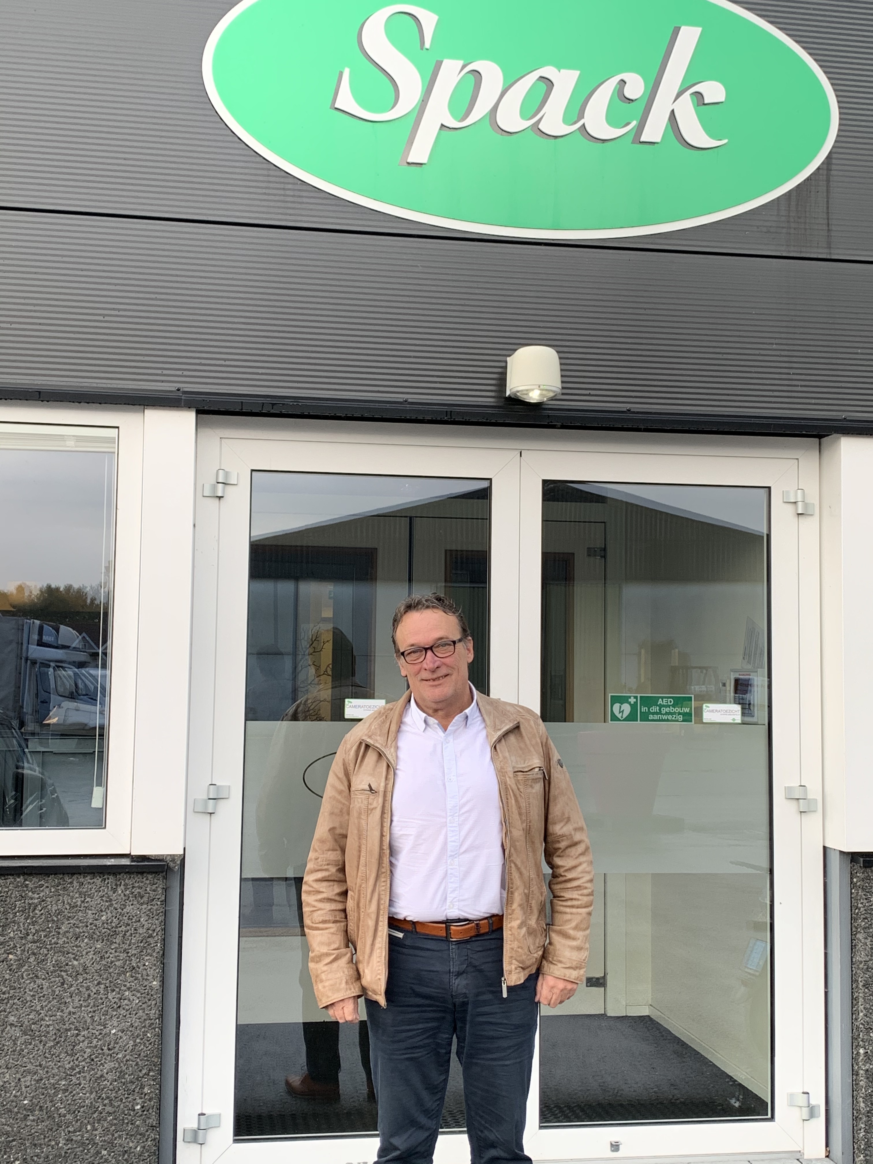 man standing infront of a Spack warehouse